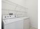 Laundry room with washer, dryer, and ample shelving at 3427 Kayla Cir, Oviedo, FL 32765