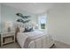 Comfortable bedroom with a large window, nightstands, and neutral decor at 3576 Fort Mellon Ln, Sanford, FL 32773