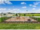 Community playground with playset, slide, and picnic tables, enclosed in a black metal fence at 3576 Fort Mellon Ln, Sanford, FL 32773