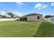 Large grassy backyard with privacy fence and view of the house at 381 Skyview Pl, Chuluota, FL 32766