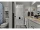 Bright bathroom featuring a double sink vanity with marble countertop and wood-look tile floors at 381 Skyview Pl, Chuluota, FL 32766