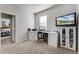 Bedroom featuring a desk with office equipment, tv, and neutral carpet at 381 Skyview Pl, Chuluota, FL 32766