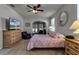 Main bedroom with TV, dresser, and sitting area at 381 Skyview Pl, Chuluota, FL 32766