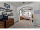 Bedroom with neutral carpet, ceiling fan, and archway to an office area at 381 Skyview Pl, Chuluota, FL 32766