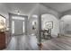 Welcoming foyer features a dining area, light gray wood flooring, and an abundance of natural light, setting an inviting tone at 381 Skyview Pl, Chuluota, FL 32766