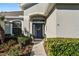 Inviting front entry with a navy blue door and landscaping at 381 Skyview Pl, Chuluota, FL 32766