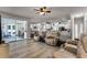 Bright living room with sliding glass doors, ceiling fan, and wood-look floors at 381 Skyview Pl, Chuluota, FL 32766