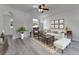 Bright living room featuring neutral walls, a ceiling fan, and light gray wood floors, perfect for entertaining guests at 381 Skyview Pl, Chuluota, FL 32766