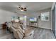 Cozy living room featuring reclining leather furniture, ceiling fan, and wood-look floors at 381 Skyview Pl, Chuluota, FL 32766