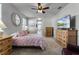 Serene main bedroom features a ceiling fan, dresser, and plenty of natural light at 381 Skyview Pl, Chuluota, FL 32766