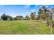 Expansive backyard showcasing lush green lawn and mature trees, offering ample space for outdoor activities and relaxation at 3943 W Campbell Rd, Lakeland, FL 33810