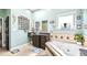 Nautical themed bathroom with tiled tub and walk in glass block shower at 3943 W Campbell Rd, Lakeland, FL 33810