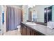 Well-lit bathroom showcasing a spacious vanity and a patterned shower curtain at 3943 W Campbell Rd, Lakeland, FL 33810