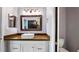 Bathroom featuring a vanity with modern fixtures, white vessel sink, and a warm brown countertop at 3943 W Campbell Rd, Lakeland, FL 33810