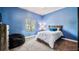 Blue bedroom with a cozy beanbag and a natural light window at 3943 W Campbell Rd, Lakeland, FL 33810