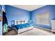 Blue bedroom with a bed featuring a built-in bookshelf headboard at 3943 W Campbell Rd, Lakeland, FL 33810