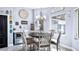 Inviting breakfast nook with round wood table, white chairs, and bright natural light from surrounding windows at 3943 W Campbell Rd, Lakeland, FL 33810