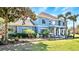 Stunning two-story home with a blue exterior, lush landscaping, fountain, and inviting front porch at 3943 W Campbell Rd, Lakeland, FL 33810