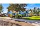 Charming two-story home boasts lush landscaping, a fountain, and a long driveway leading to the garage at 3943 W Campbell Rd, Lakeland, FL 33810