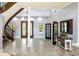 Open foyer showcasing a curved staircase, decorative front door, and bright natural light at 3943 W Campbell Rd, Lakeland, FL 33810