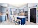 Stylish kitchen with blue island, white countertops, stainless steel appliances, and a decorative pantry door at 3943 W Campbell Rd, Lakeland, FL 33810