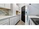 Convenient laundry room with white cabinets, mosaic backsplash, and a modern washer and dryer at 3943 W Campbell Rd, Lakeland, FL 33810