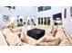 Open-concept living room with a large sectional, fireplace, sliding glass doors, and views of the kitchen at 3943 W Campbell Rd, Lakeland, FL 33810