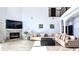 Spacious living room with a fireplace, high ceilings, tile floors, and large comfortable sectional couch at 3943 W Campbell Rd, Lakeland, FL 33810