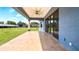 Covered patio with tile flooring, ceiling fan, and sliding glass doors, offering a view of the expansive backyard at 3943 W Campbell Rd, Lakeland, FL 33810