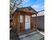 Small shed featuring a wooden structure, covered porch, and concrete steps, perfect for outdoor storage at 3943 W Campbell Rd, Lakeland, FL 33810