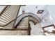 Elegant winding staircase with carpeted steps and dark wood railing creates a grand entrance at 3943 W Campbell Rd, Lakeland, FL 33810