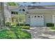 Condo building with a white garage door and manicured landscaping at 3992 Radley Ct, Longwood, FL 32779