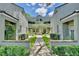 Neat courtyard entry to a two-story condo building with lush landscaping at 3992 Radley Ct, Longwood, FL 32779