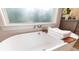 Close-up view of a modern, freestanding bathtub with wooden tray at 400 W Hazel St, Orlando, FL 32804