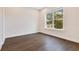 Bright bedroom with dark hardwood floors and large window at 400 W Hazel St, Orlando, FL 32804