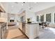 Open concept kitchen with white cabinets, a large island, and stainless steel appliances at 400 W Hazel St, Orlando, FL 32804