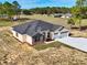 House exterior with a three-car garage and driveway at 41289 County Road, 452, Leesburg, FL 34788