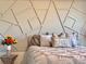 Gray bed with accent pillows and geometric wall at 41289 County Road, 452, Leesburg, FL 34788