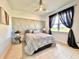 Bedroom with gray bedding, geometric accent wall, and natural light at 41289 County Road, 452, Leesburg, FL 34788