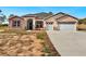 Two-story house with stone accents, three-car garage, and a large driveway at 41289 County Road, 452, Leesburg, FL 34788