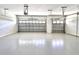 Spacious two-car garage with light-grey epoxy flooring at 41289 County Road, 452, Leesburg, FL 34788