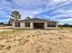 Single-story house with a brown roof and landscaped yard at 41289 County Road, 452, Leesburg, FL 34788