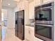 Modern kitchen with stainless steel double oven and refrigerator at 41289 County Road, 452, Leesburg, FL 34788