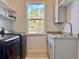 Laundry room with utility sink, washer, dryer, and window at 41289 County Road, 452, Leesburg, FL 34788