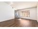 Living room featuring hardwood floors and a large window at 425 Iowa Woods E Cir, Orlando, FL 32824