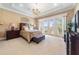 Serene bedroom with water views and access to balcony at 4326 Isabella Cir, Windermere, FL 34786