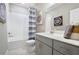 Bathroom with gray vanity, white subway tile, and a tub shower combination at 4418 Small Creek Rd, Kissimmee, FL 34744