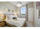 Cozy bedroom with light wood bed frame, neutral decor and ample natural light at 4418 Small Creek Rd, Kissimmee, FL 34744