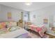 ' bedroom with twin beds and pastel decor at 4705 Pershoie Ln, Kissimmee, FL 34746