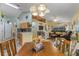 Open dining area with wood table and view into living room at 4705 Pershoie Ln, Kissimmee, FL 34746